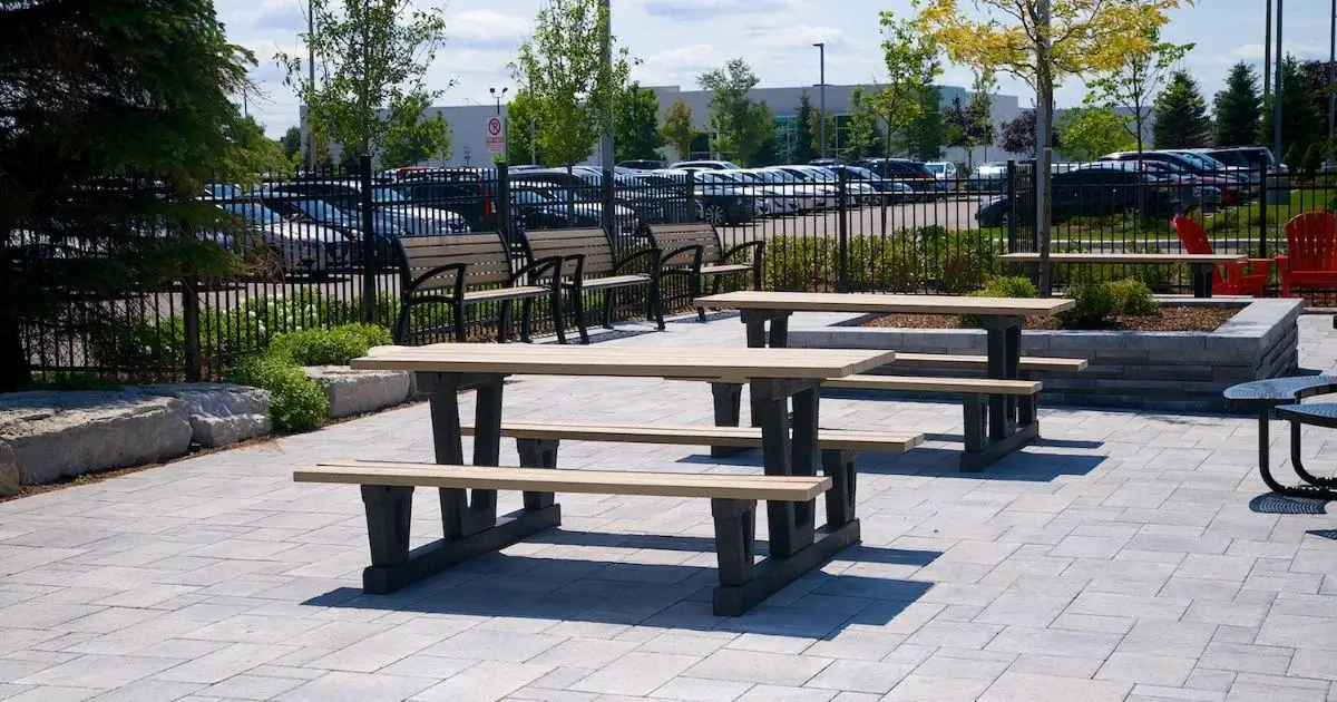 Picnic tables and benches in a company outdoor seating area.